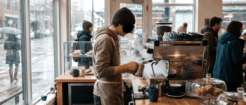 A student working a café shift within the study permit work hours